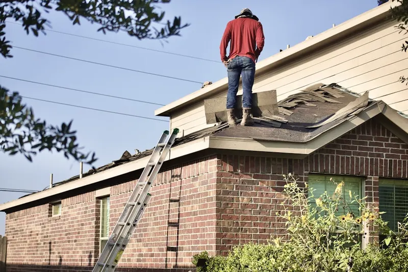 Professional roofer working on a residential roof in Estates at Cedar Hill